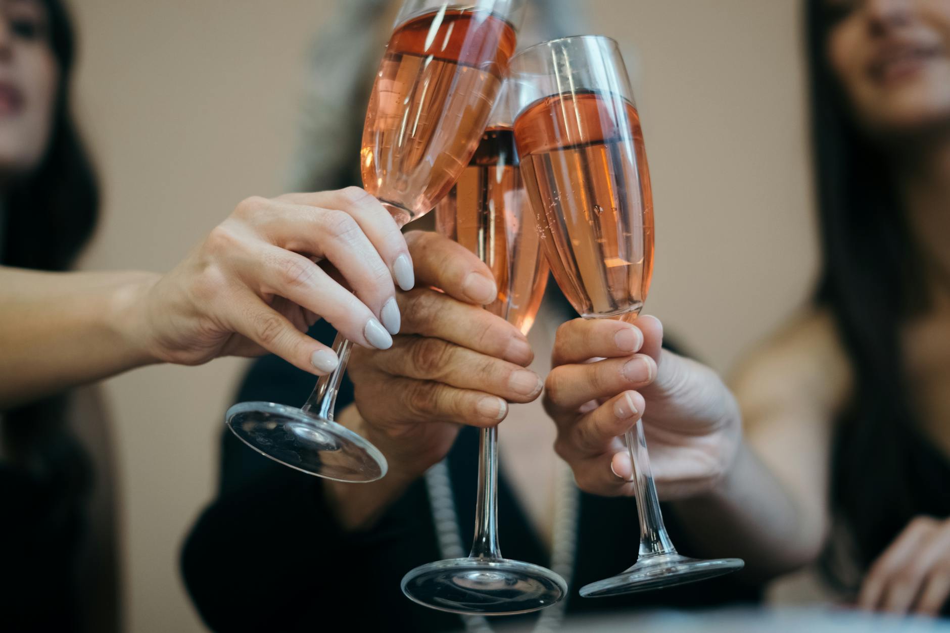 women clinking their wine glasses