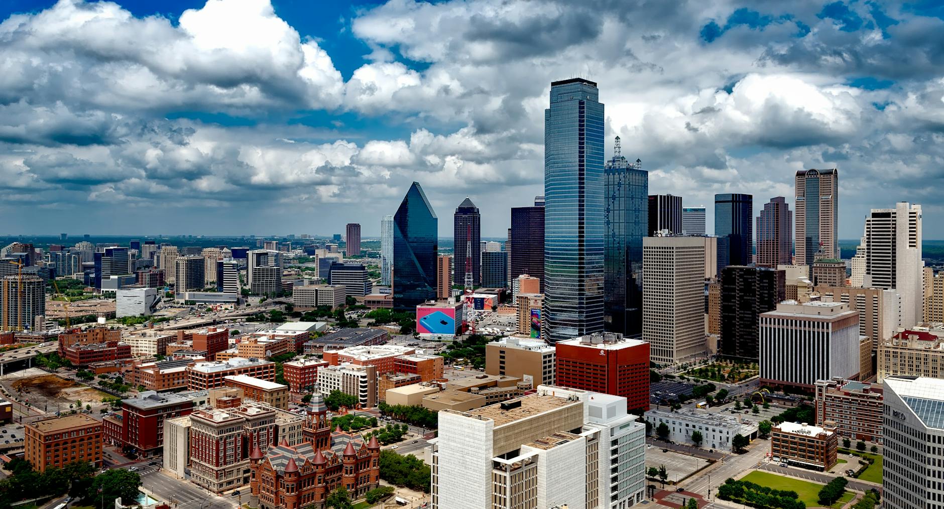 aerial photo of city under white clouds