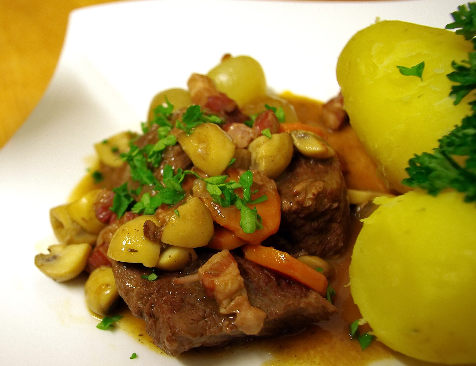 Boeuf bourguignon with mushrooms and potatoes on a plate