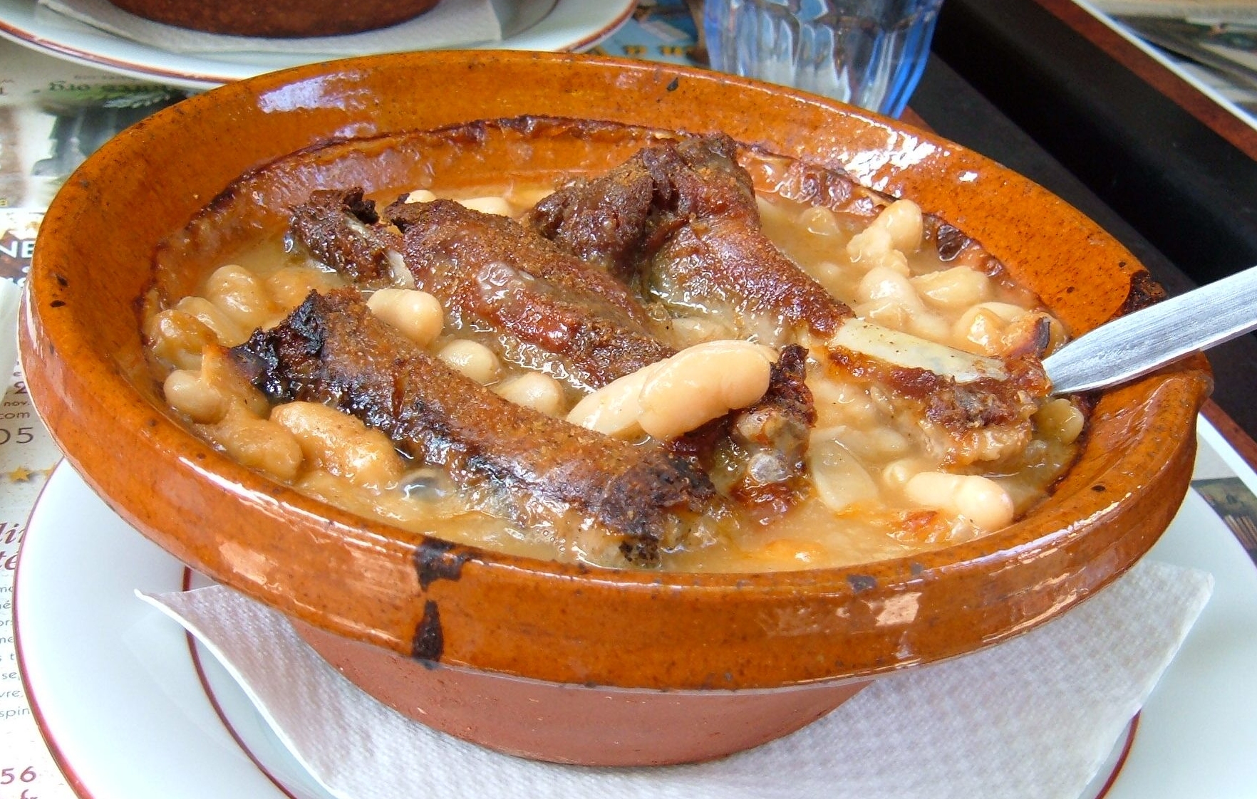 A bowl of cassoulet with beans and sausage