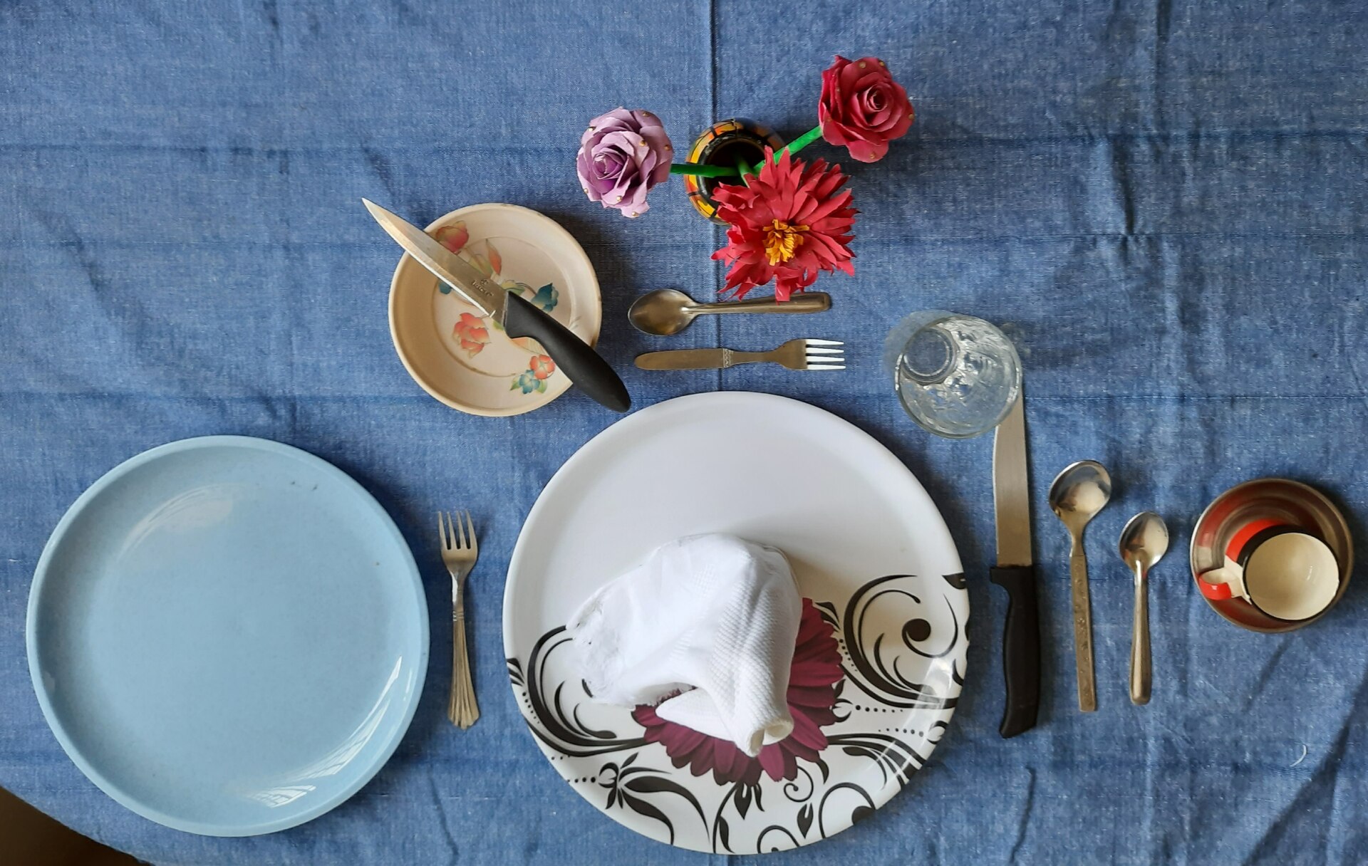 A simple fall table setting with plates and flatware laid out