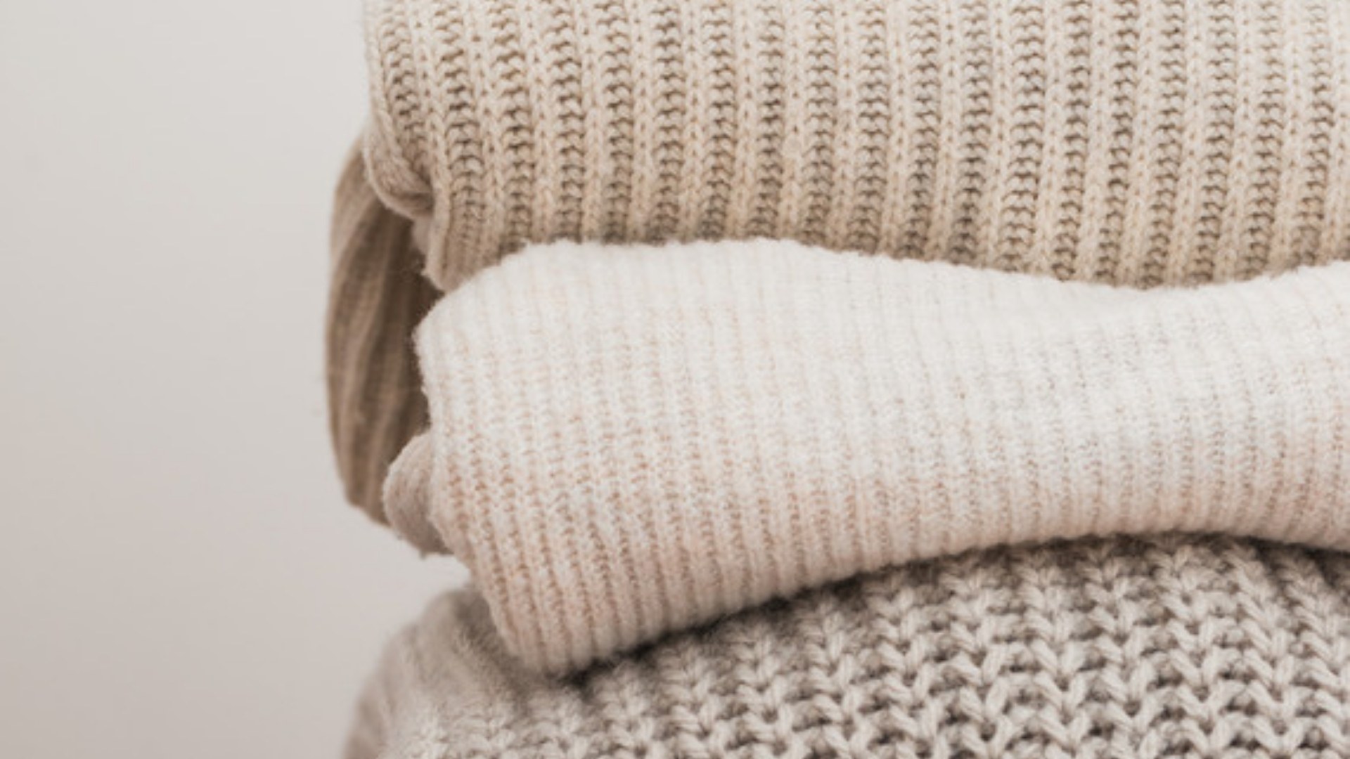 Stack of folded knit sweaters