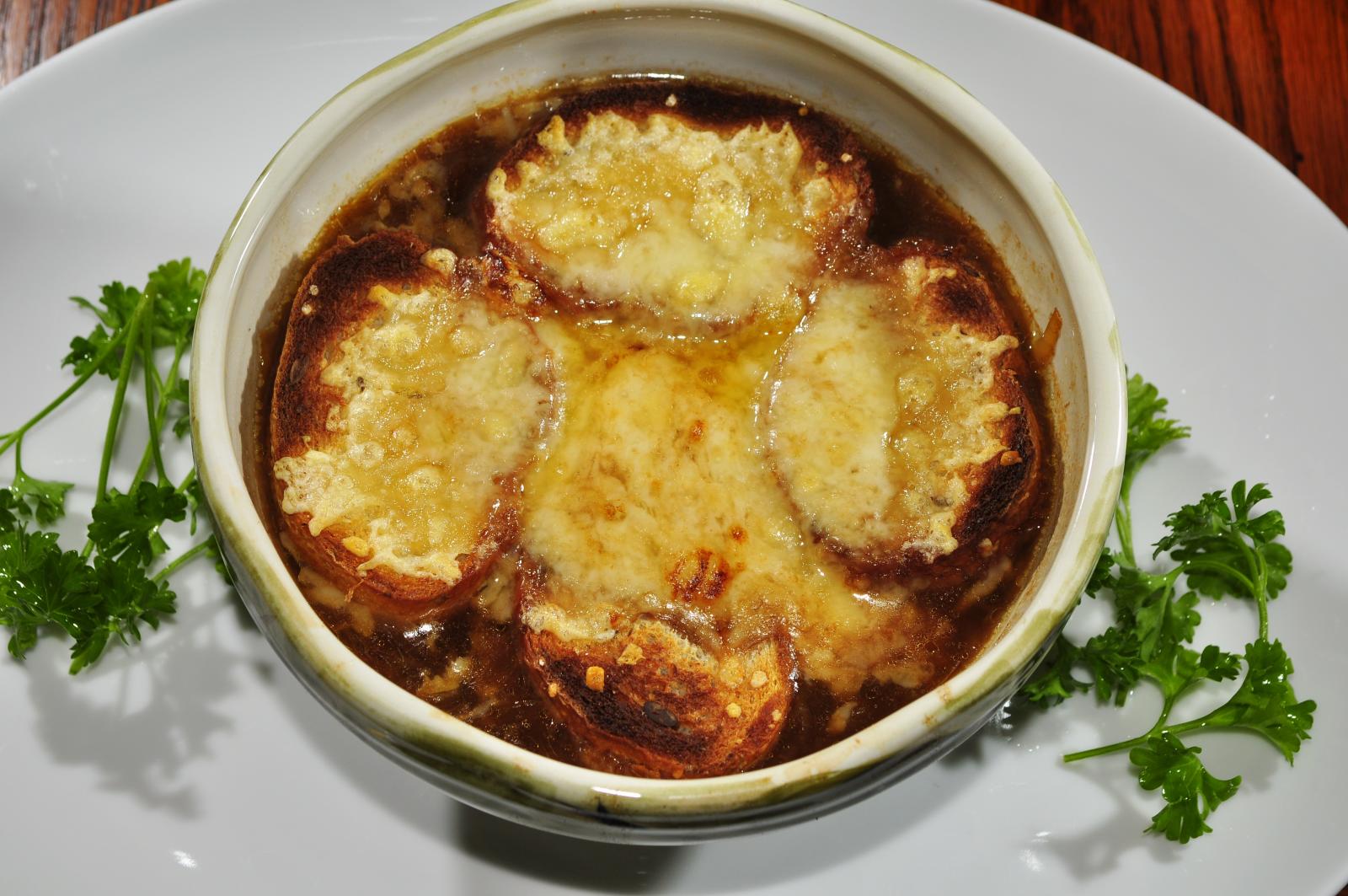 A bowl of French onion soup with a browned cheese crust