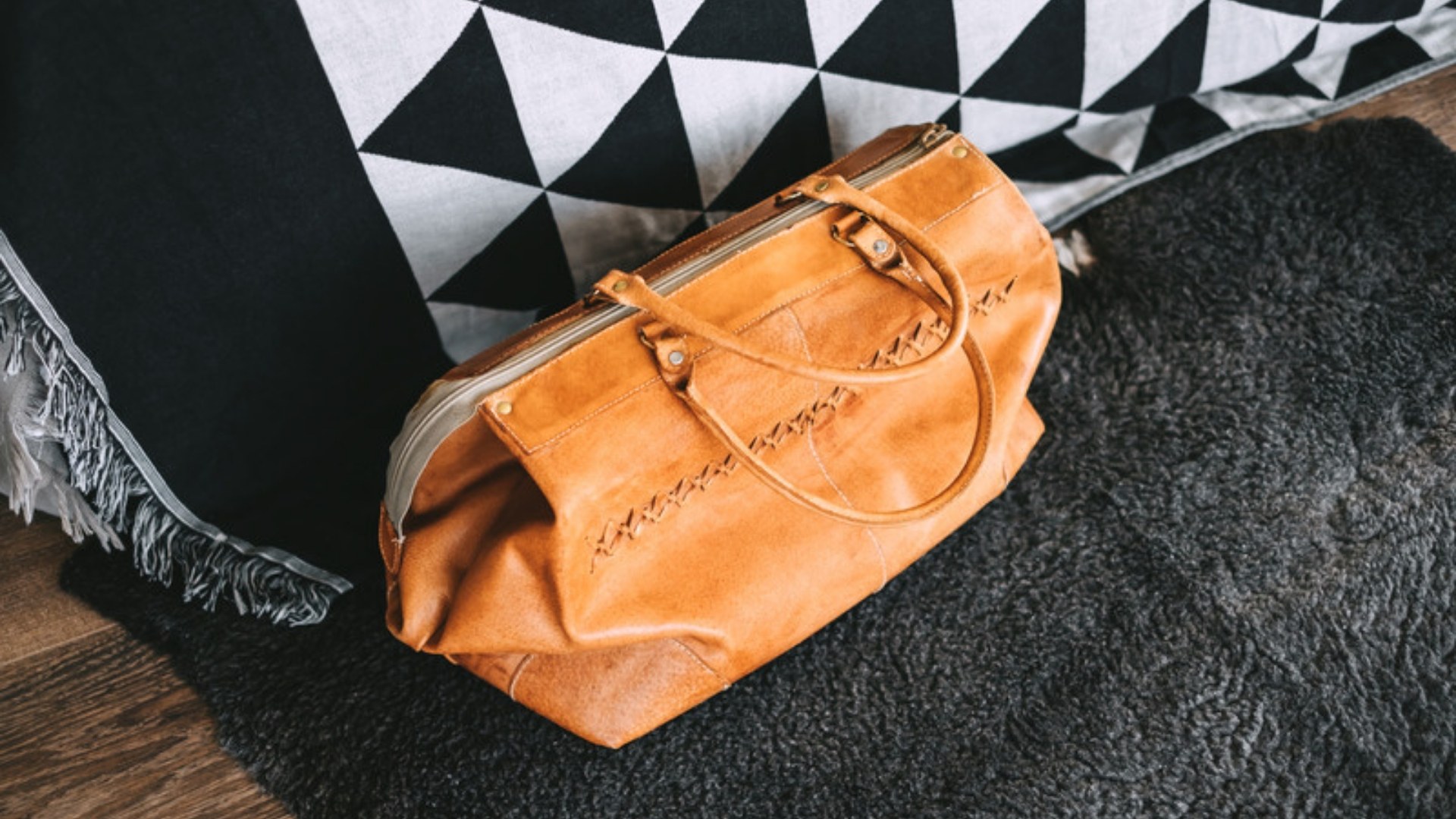 Leather weekend bag by the bed