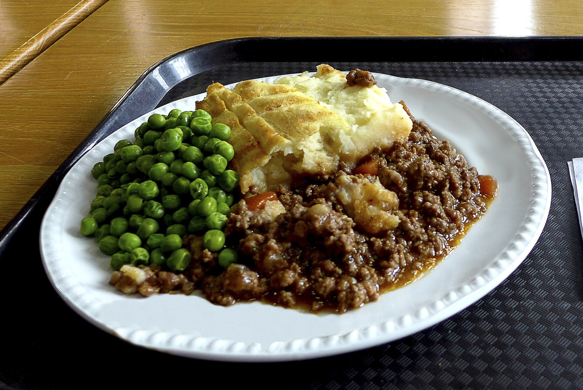 A serving of shepherd's pie with peas