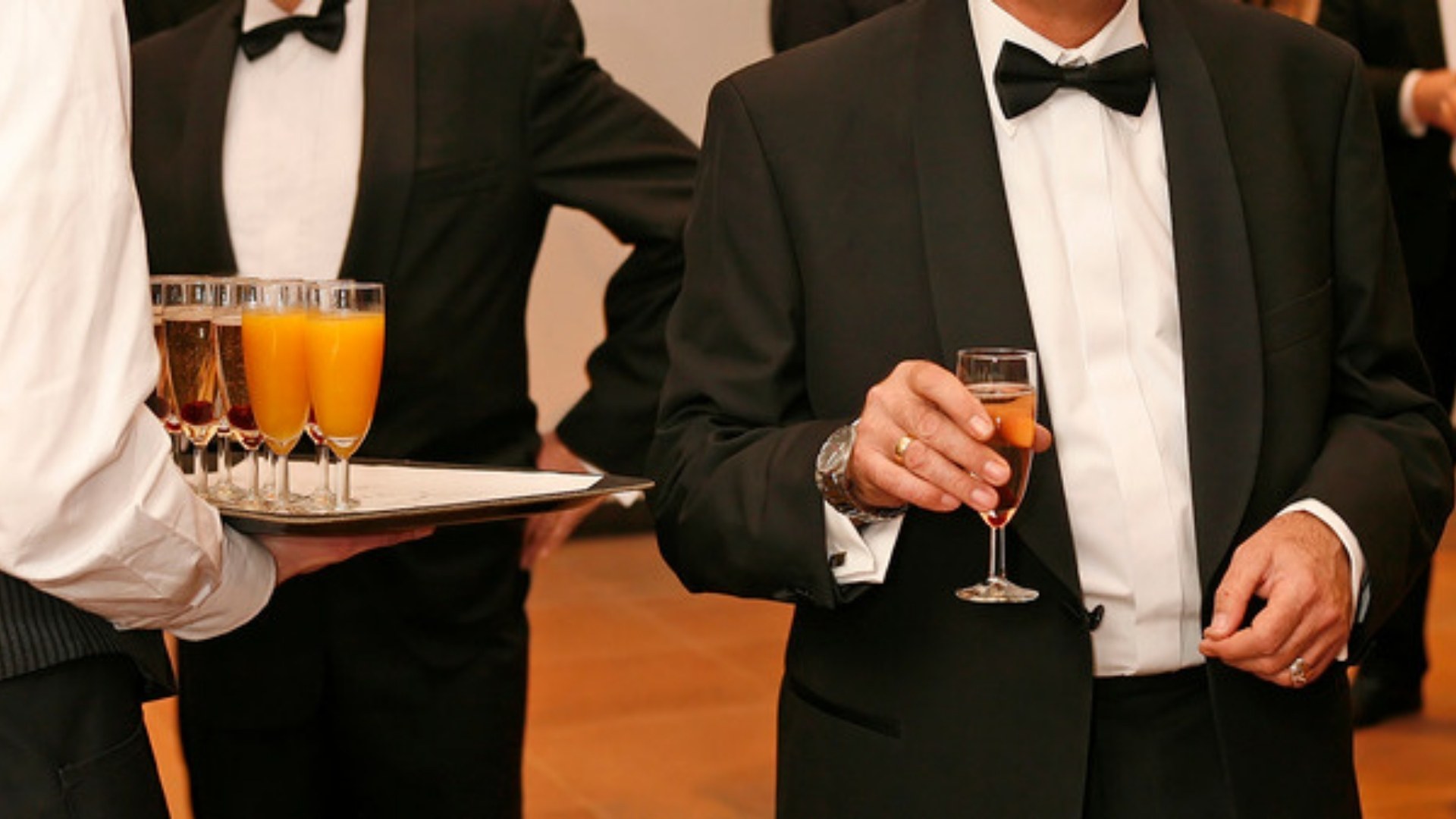 Guests in tuxedos at a gala reception